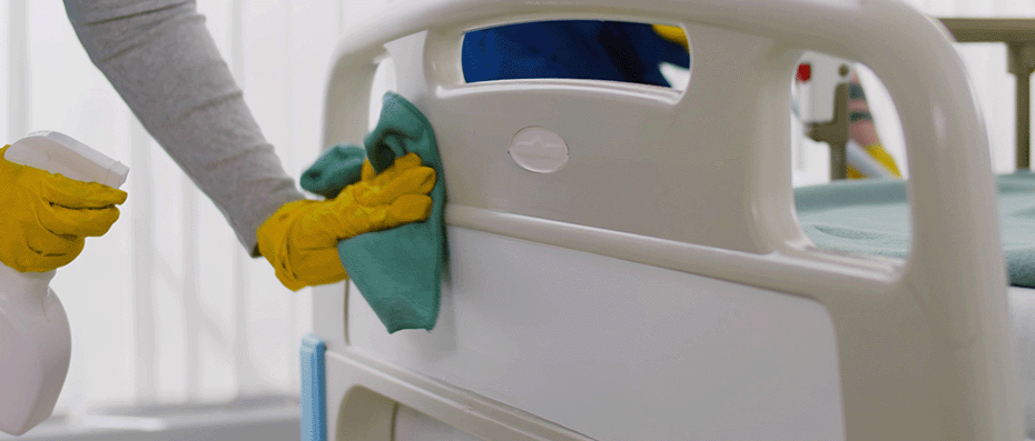 professional cleaners disinfecting hospital room