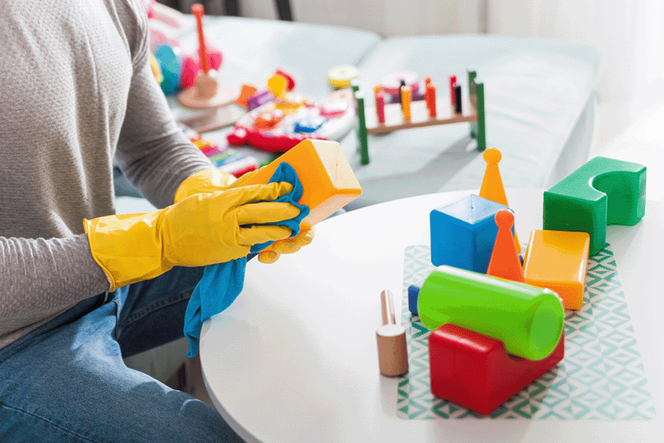 a man cleaning toys at a daycare center