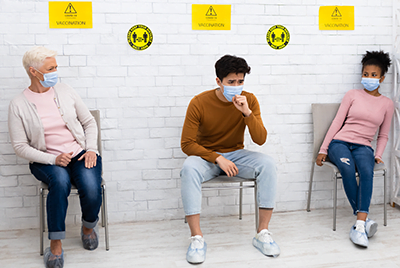 patient coughing in waiting room while 2 other patients back away from him